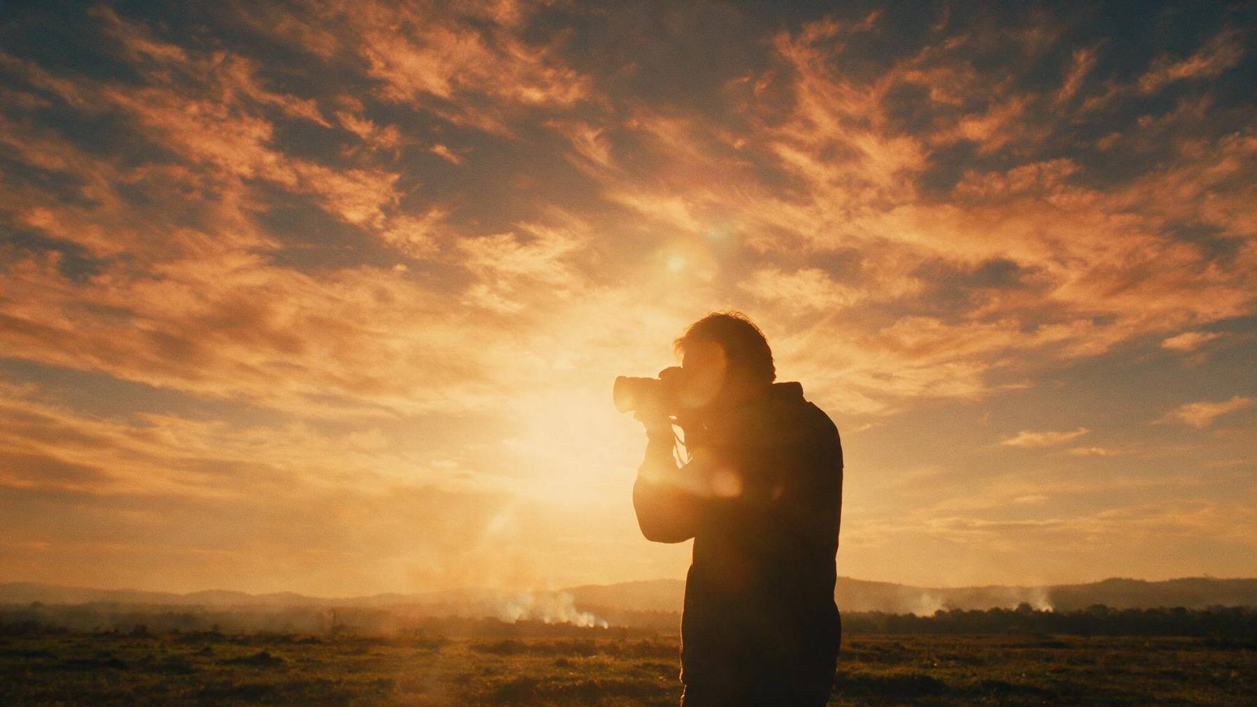 Videographer shooting at golden hour