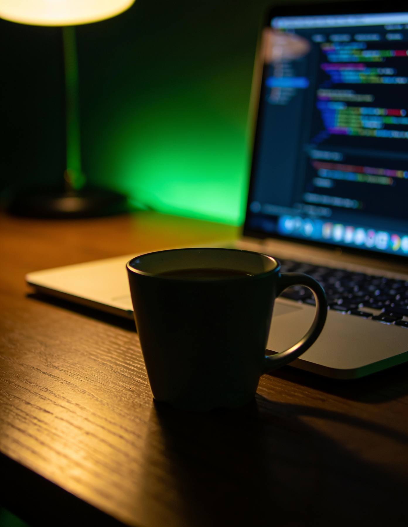 Laptop with code on a desk, INNOVAT3 web development